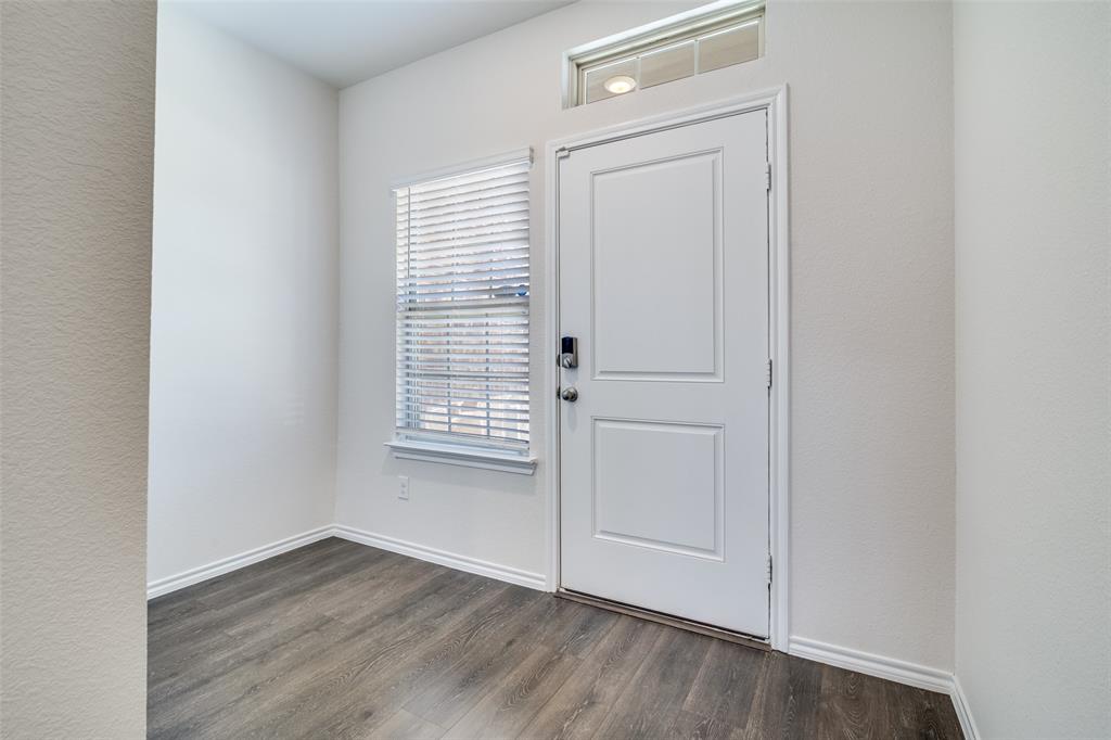 3025 Frazier Street Forney, TX 75126 - Photo 4 of 25 an empty room with wooden floor and windows