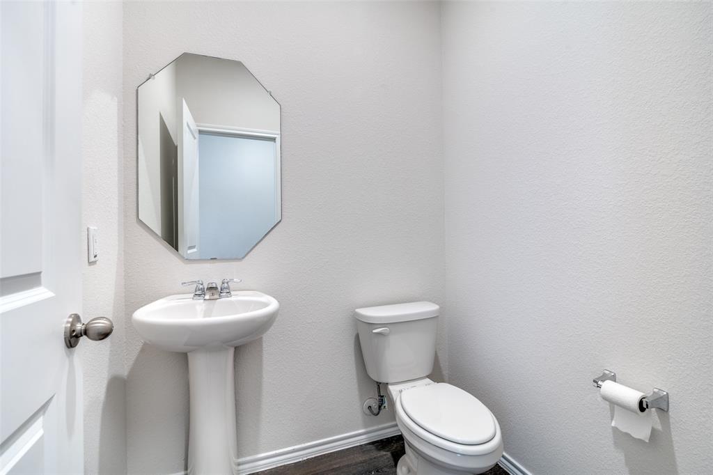 3025 Frazier Street Forney, TX 75126 - Photo 5 of 25 a bathroom with a toilet sink and mirror