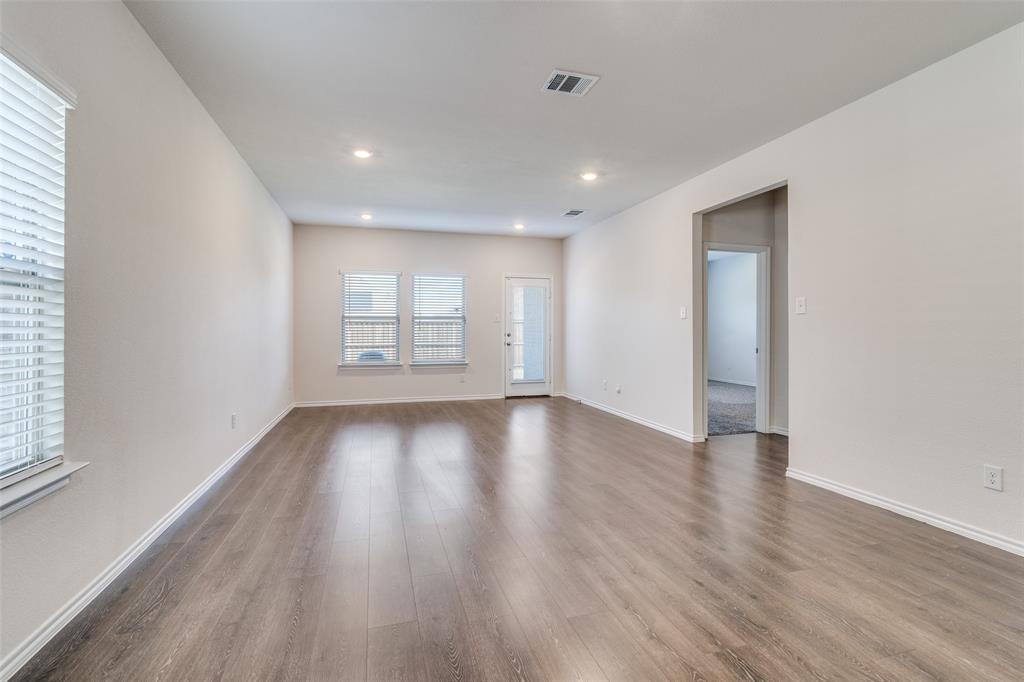 3025 Frazier Street Forney, TX 75126 - Photo 6 of 25 an empty room with wooden floor and window