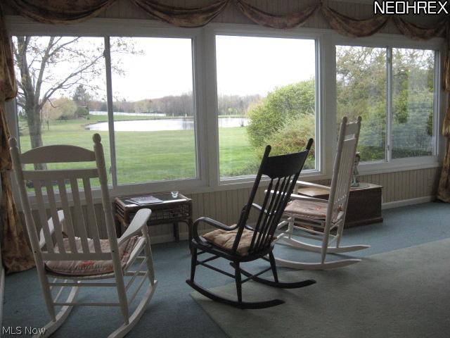 7407 Cedar Road Chesterland, OH 44026 - Photo 2 of 25 Sit in your favorite rocker & enjoy the views of the pond in this thee season room.