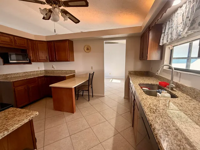 a kitchen with a sink a stove and cabinets