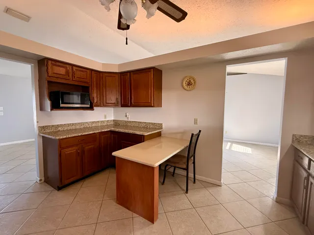 a kitchen with a stove a sink and a microwave