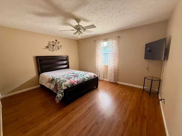a bedroom with a bed and a flat screen tv