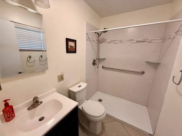 a bathroom with a sink toilet and shower