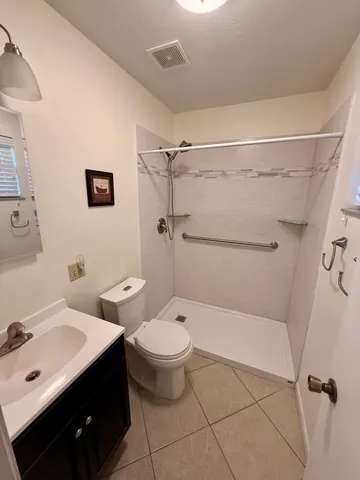 a bathroom with a toilet sink and shower
