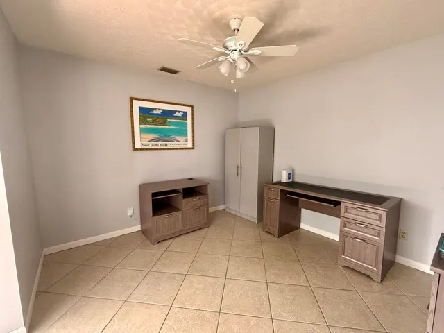 a kitchen with granite countertop a stove a sink and a microwave