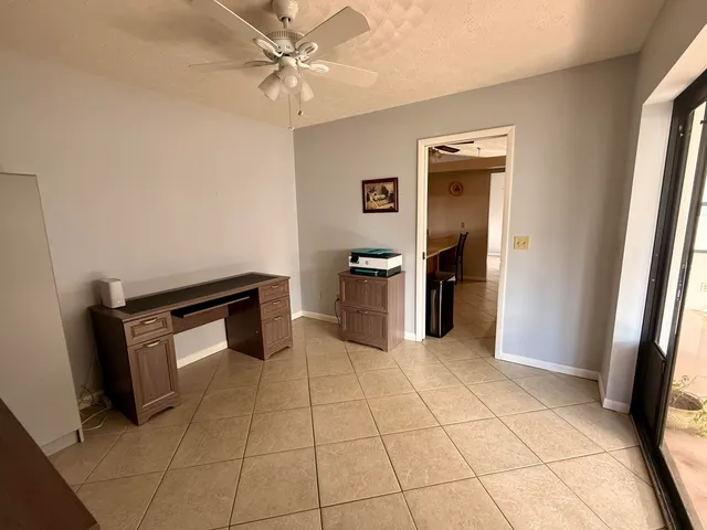 a kitchen with white cabinets and black appliances