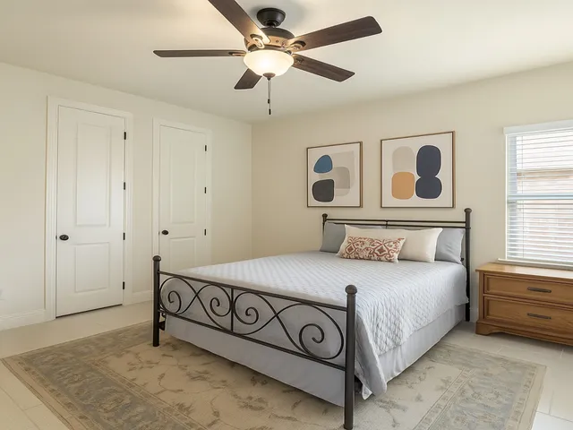 a bedroom with a bed and a window