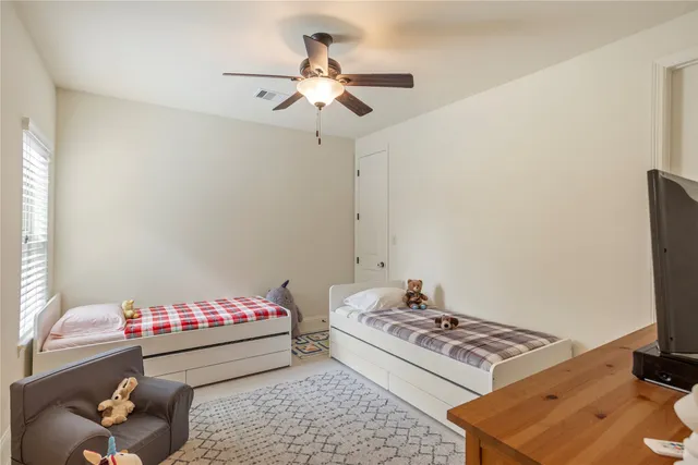 a bedroom with a bed and a couch