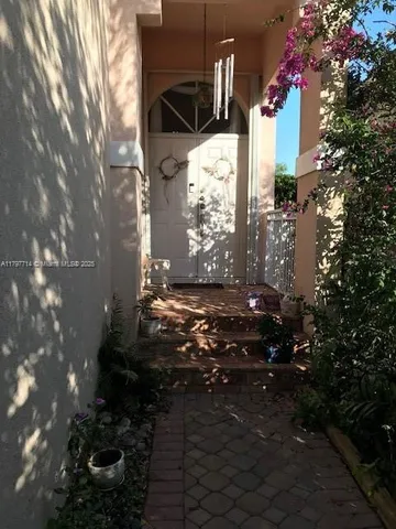 a kitchen with stainless steel appliances a sink a counter top space cabinets and a window