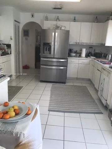 a dining room with furniture and a floor to ceiling window