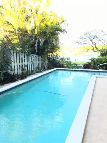 a view of a garden with wooden fence