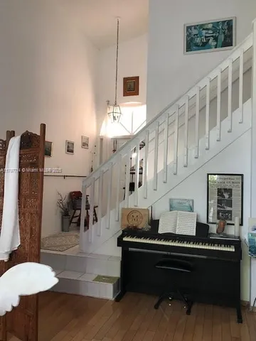 a bedroom with a bed and a flat tv screen on dresser