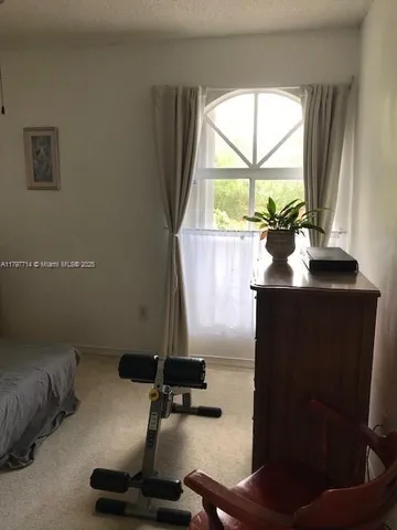 a bathroom with a large window and a shower