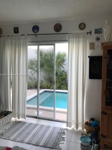 a bedroom with furniture and large windows