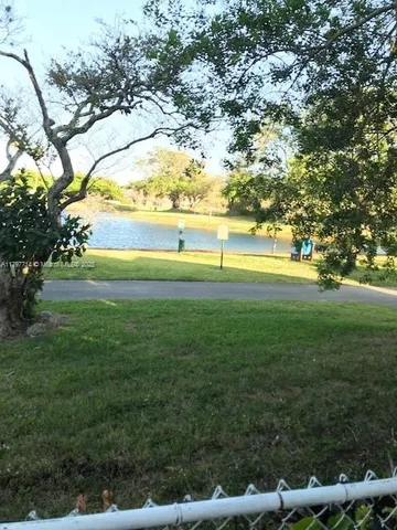 a view of field with grass and trees