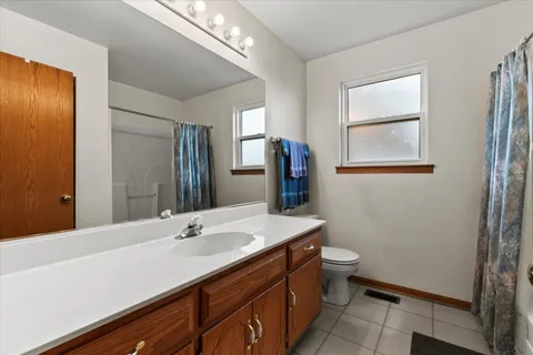 a bathroom with a sink mirror and toilet
