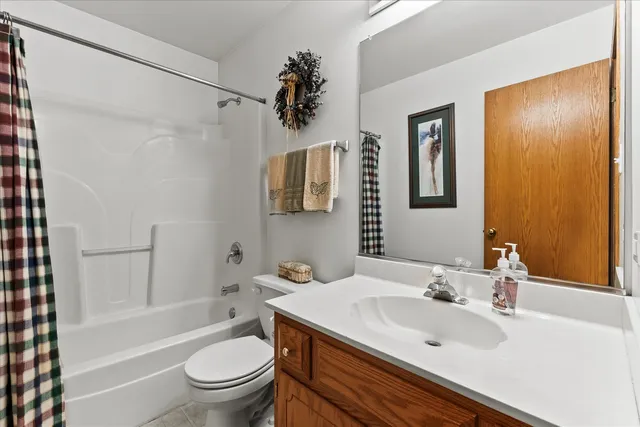a bathroom with a sink toilet tub and shower