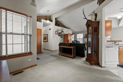 a view of a kitchen with refrigerator and windows