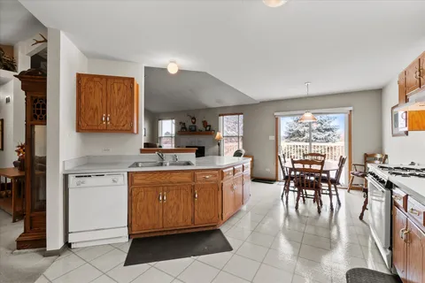 a kitchen with a dining table chairs and large counter top space