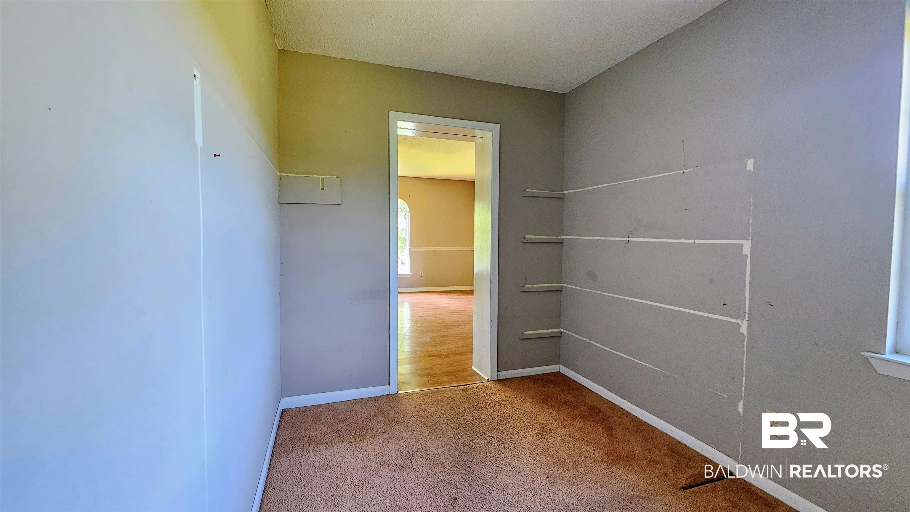 18824 Highway 41 Brewton, AL 36426 - Photo 34 of 40 Interior room featuring neutral wall tones, built-in shelving, and carpet flooring