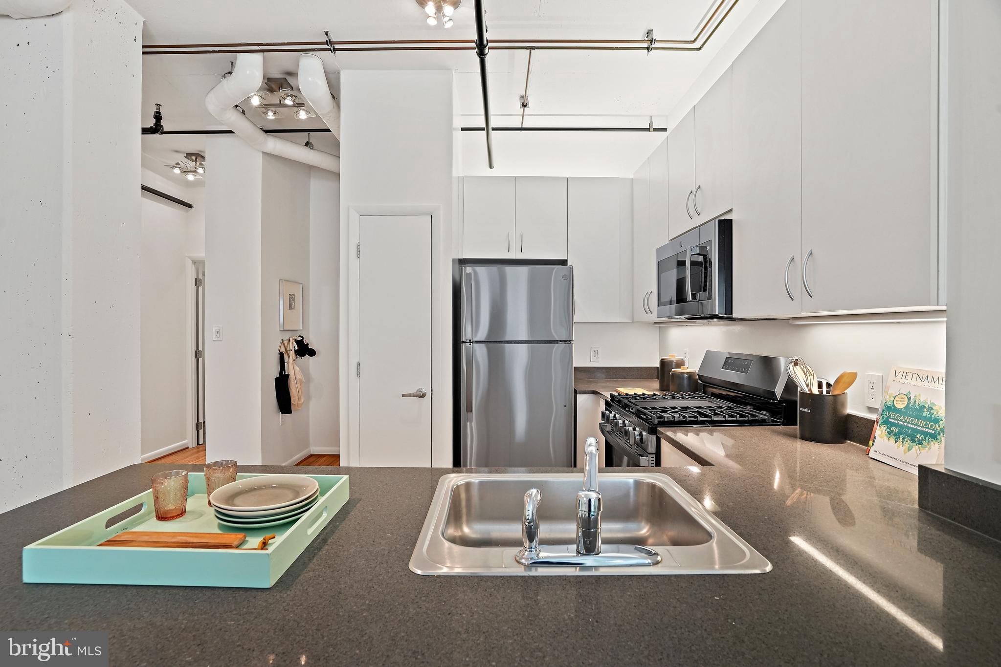 1300 N Street Northwest, Unit 106 Washington, DC 20005 - Photo 7 of 23 View of kitchen from living room