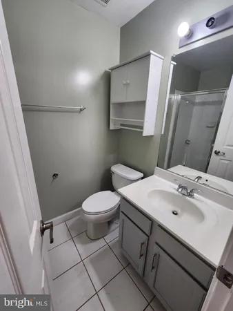 a bathroom with a sink mirror vanity and toilet