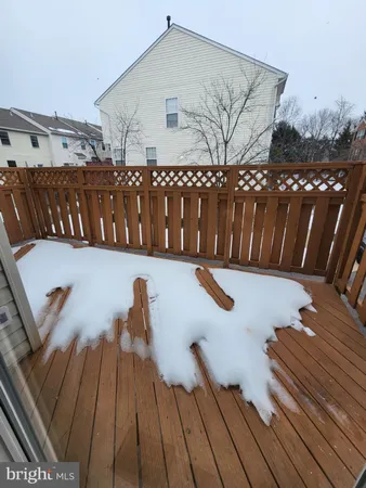 a view of a roof deck with wooden floor and fence