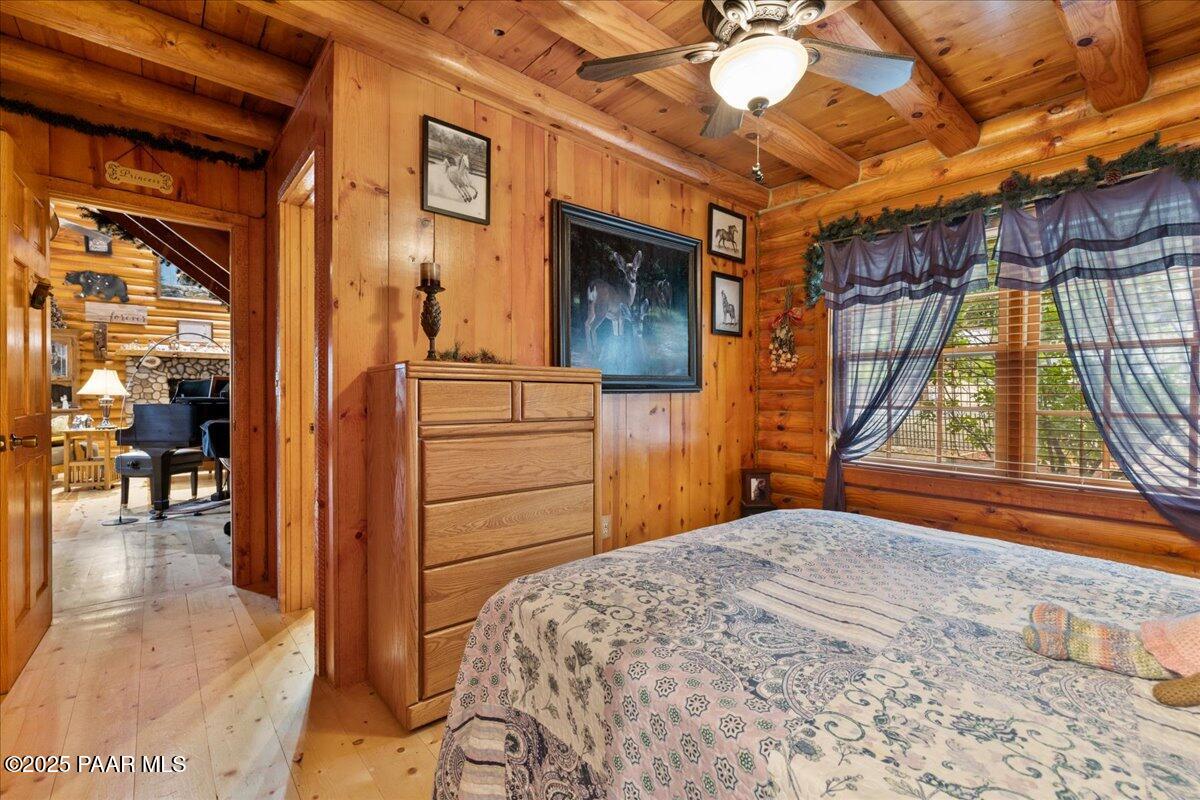 1370 East Pine Ridge Drive Prescott, AZ 86303 - Photo 22 of 32 a bedroom with a bed and a chandelier