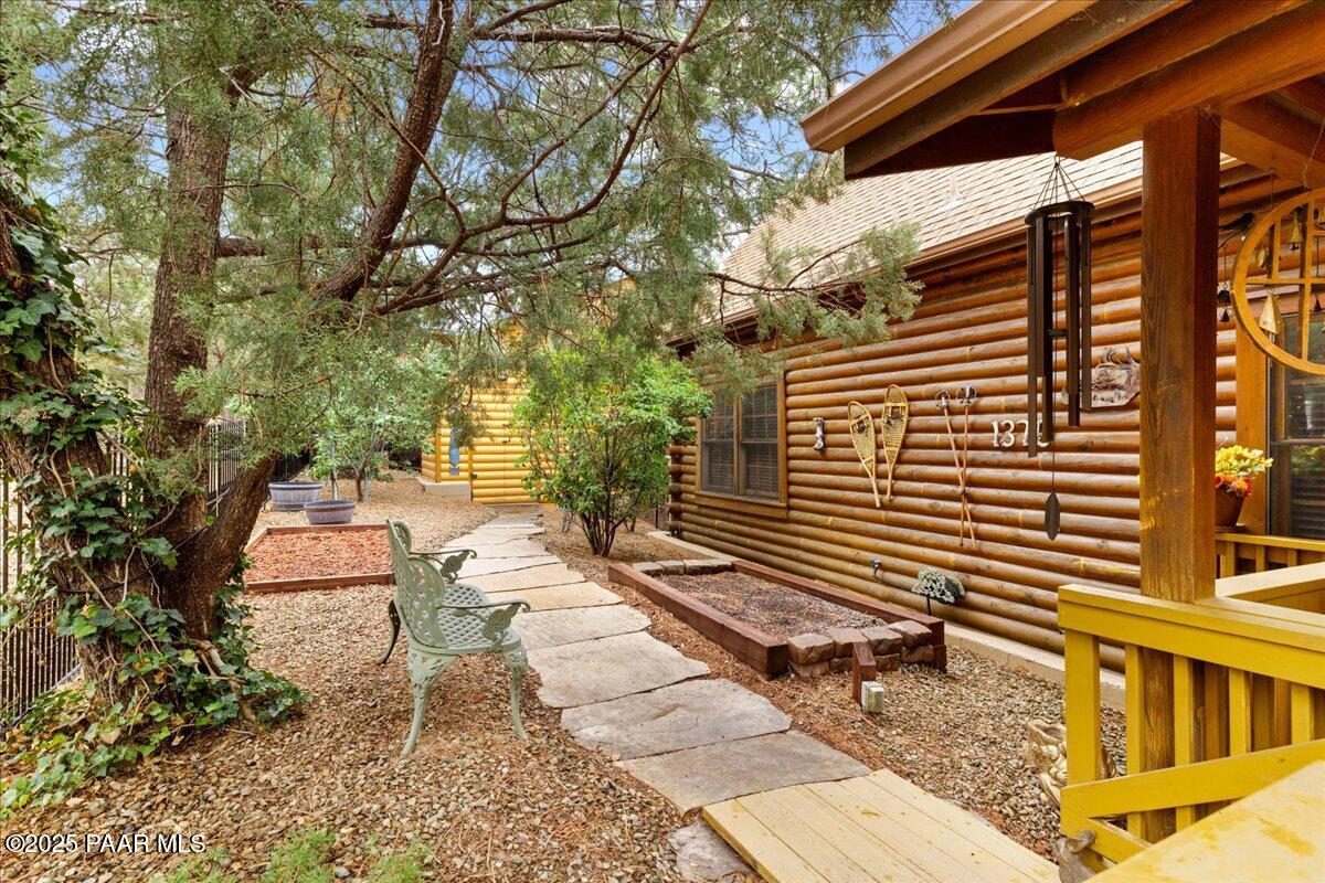 1370 East Pine Ridge Drive Prescott, AZ 86303 - Photo 4 of 32 a pathway of a house with backyard and sitting area