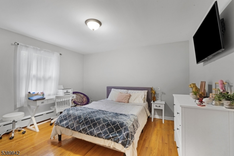 202 Mt Horeb Road Warren, NJ 07059 - Photo 12 of 23 a bedroom with a bed and flat screen tv