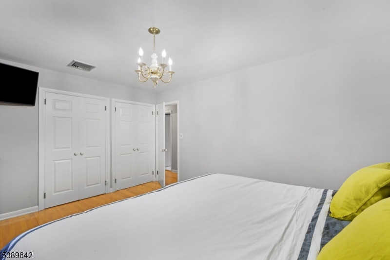 202 Mt Horeb Road Warren, NJ 07059 - Photo 14 of 23 a bedroom with a bed and a chandelier