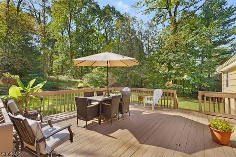 a view of backyard with seating space and trees