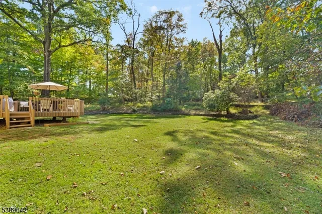 a yellow building in the middle of a yard