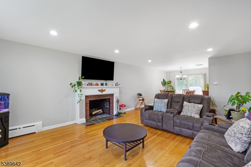 202 Mt Horeb Road Warren, NJ 07059 - Photo 5 of 23 a living room with furniture a fireplace and a flat screen tv