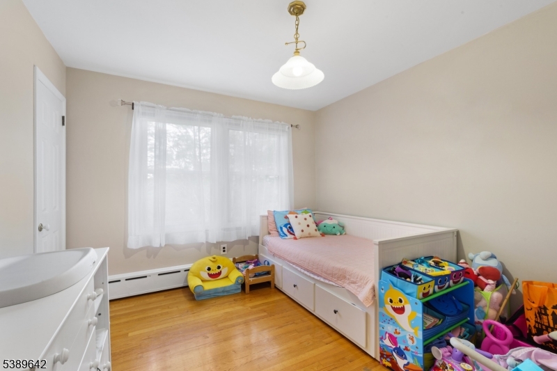 202 Mt Horeb Road Warren, NJ 07059 - Photo 10 of 23 a bedroom with a bed and a chandelier