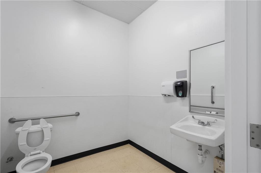 26 Front Street Millsboro, PA 15348 - Photo 23 of 24 a bathroom with a sink mirror and toilet