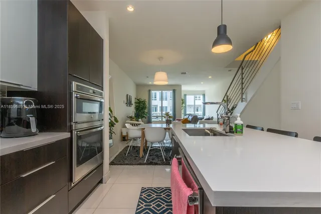 a kitchen with a sink appliances and cabinets