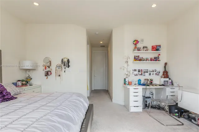 a bedroom with a bed and cabinets