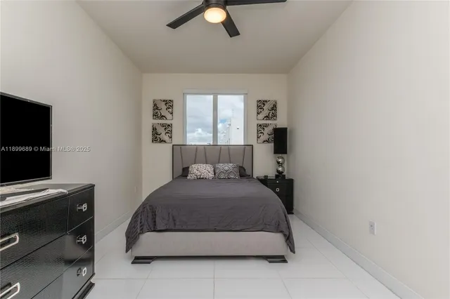 a room with a television and a mirror on dresser