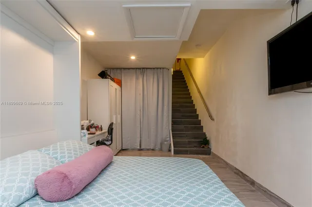 a room with a bed and a flat screen tv