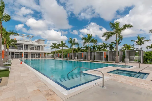 a view of a patio with couches table and chairs potted plants and palm tree