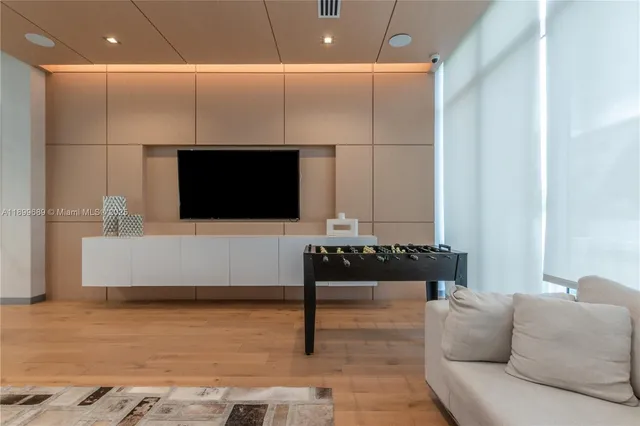 a room with pool table and windows