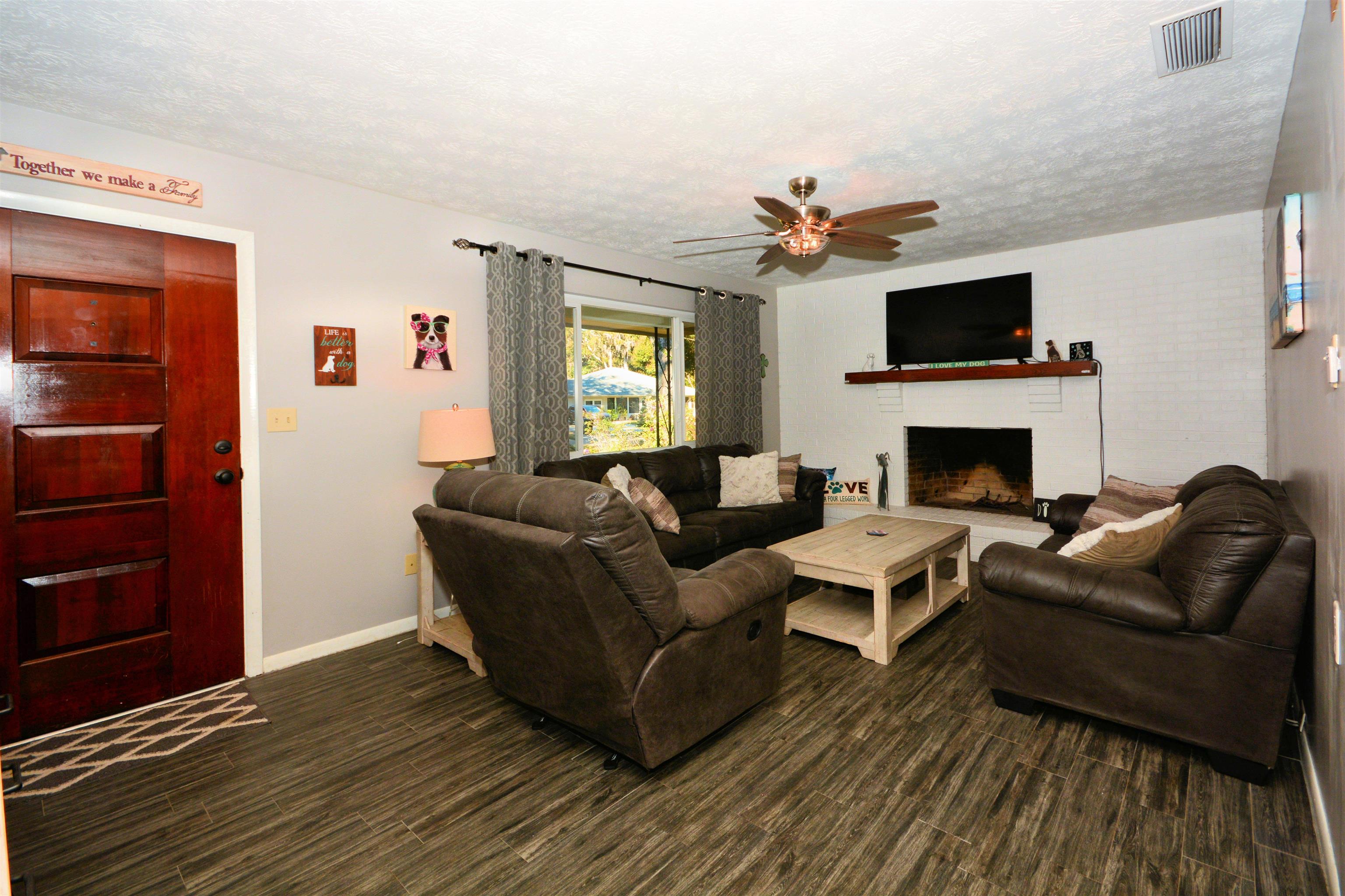 253 Mimosa Road St. Augustine, FL 32086 - Photo 14 of 42 a living room with furniture fireplace and flat screen tv