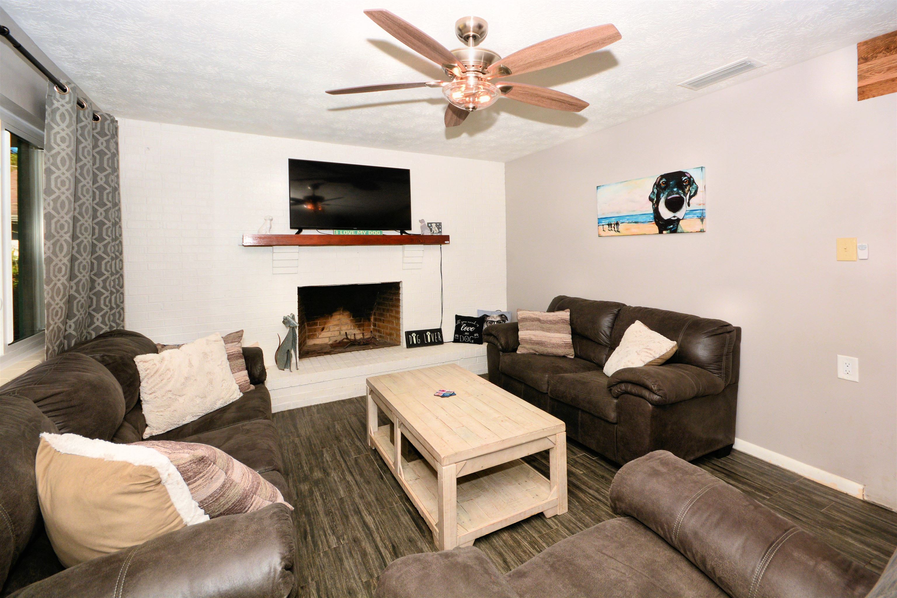 253 Mimosa Road St. Augustine, FL 32086 - Photo 15 of 42 a living room with furniture a flat screen tv and a fireplace