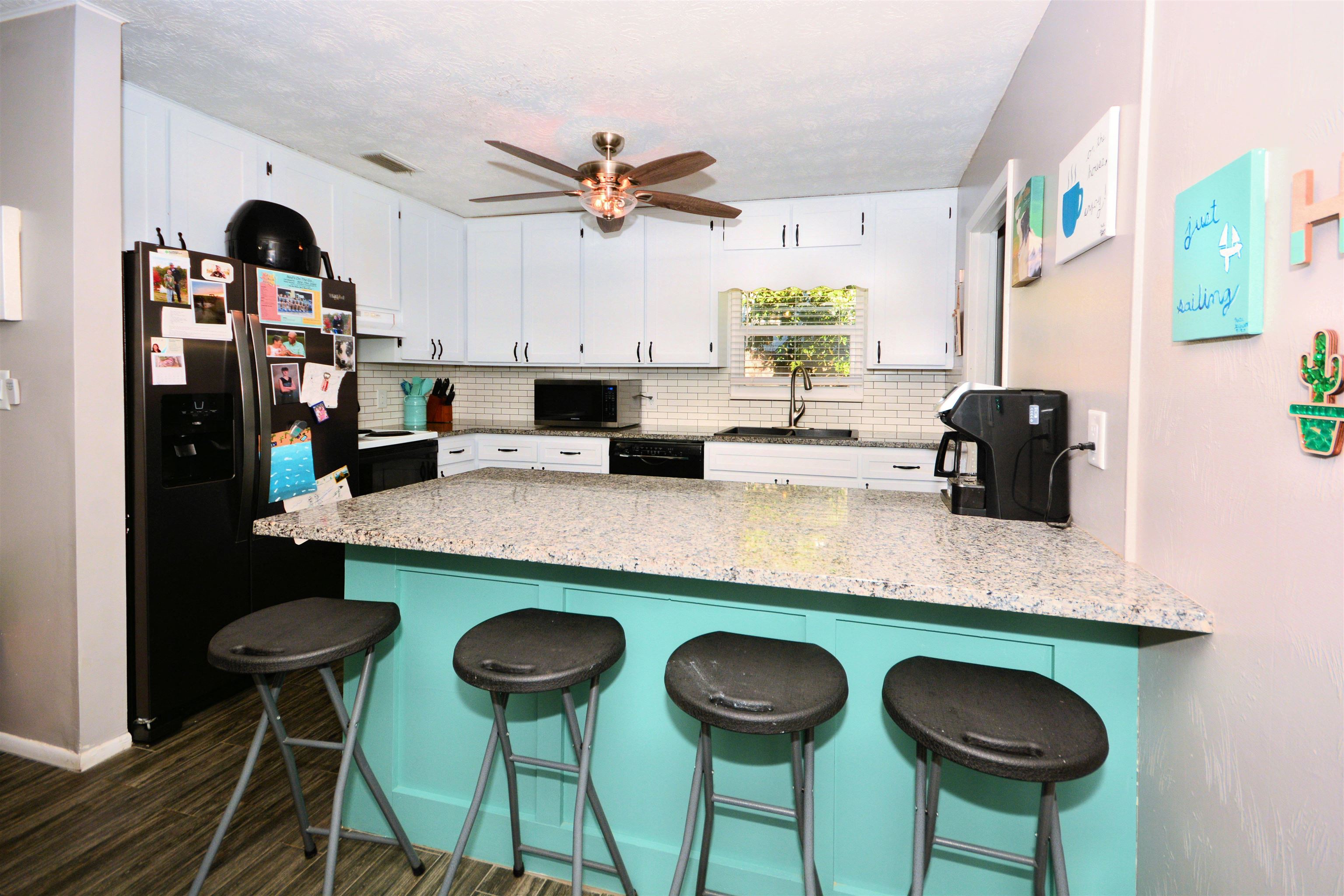 253 Mimosa Road St. Augustine, FL 32086 - Photo 22 of 42 a kitchen with a dining table chairs and a chandelier