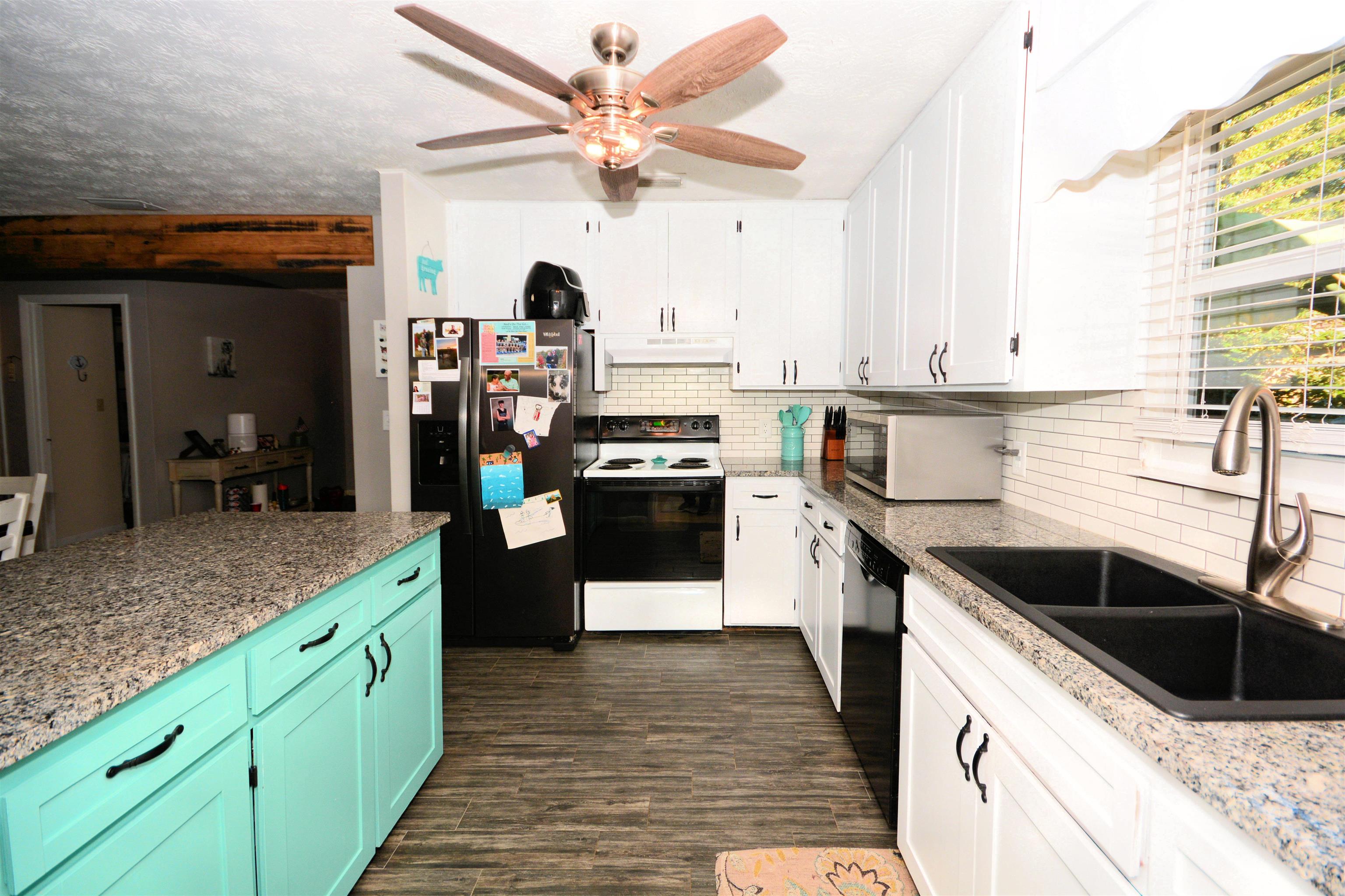 253 Mimosa Road St. Augustine, FL 32086 - Photo 23 of 42 a kitchen with stainless steel appliances granite countertop a sink a stove and a refrigerator