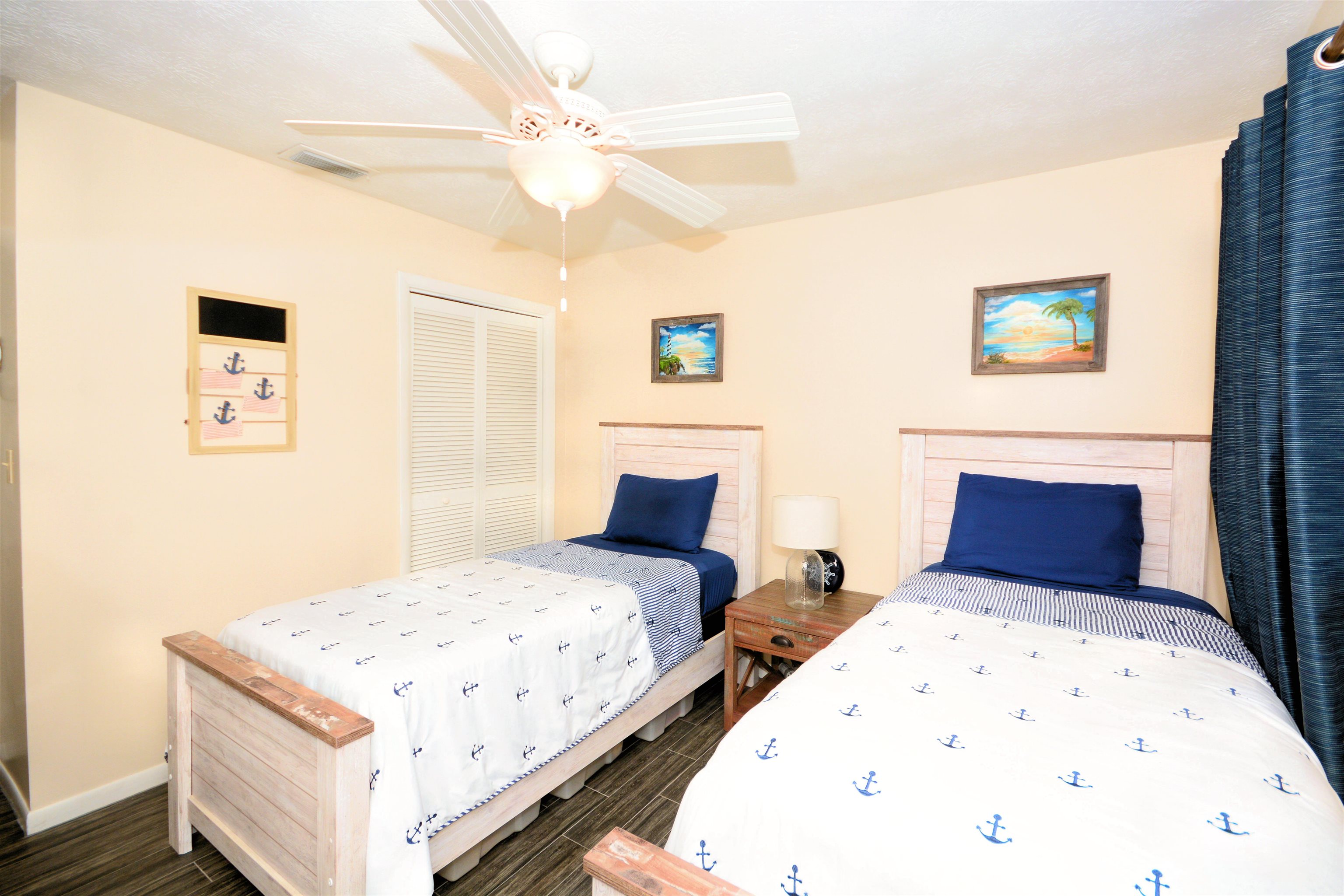 253 Mimosa Road St. Augustine, FL 32086 - Photo 27 of 42 a bedroom with a large bed and a chandelier