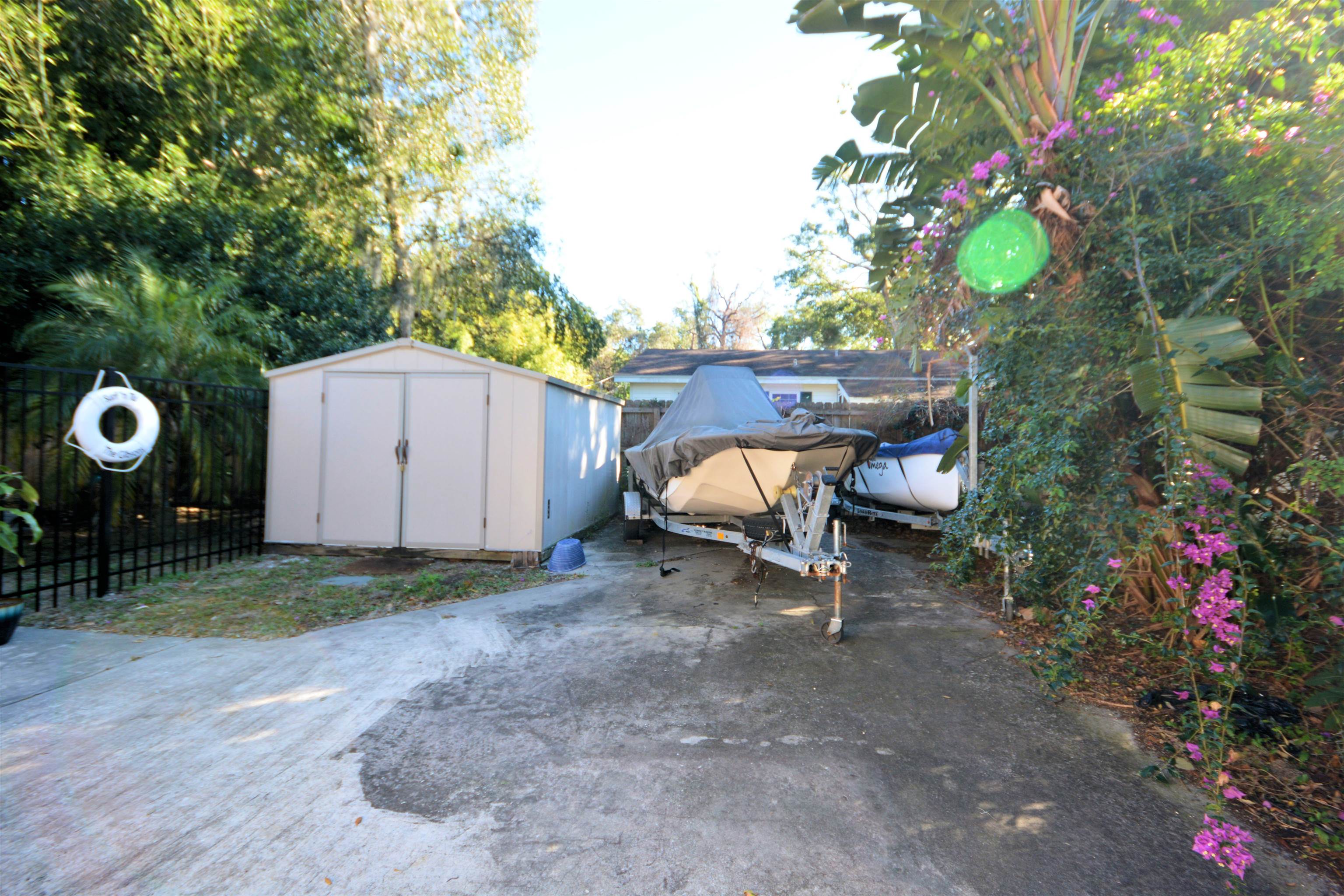 253 Mimosa Road St. Augustine, FL 32086 - Photo 40 of 42 a backyard of a house with table and chairs