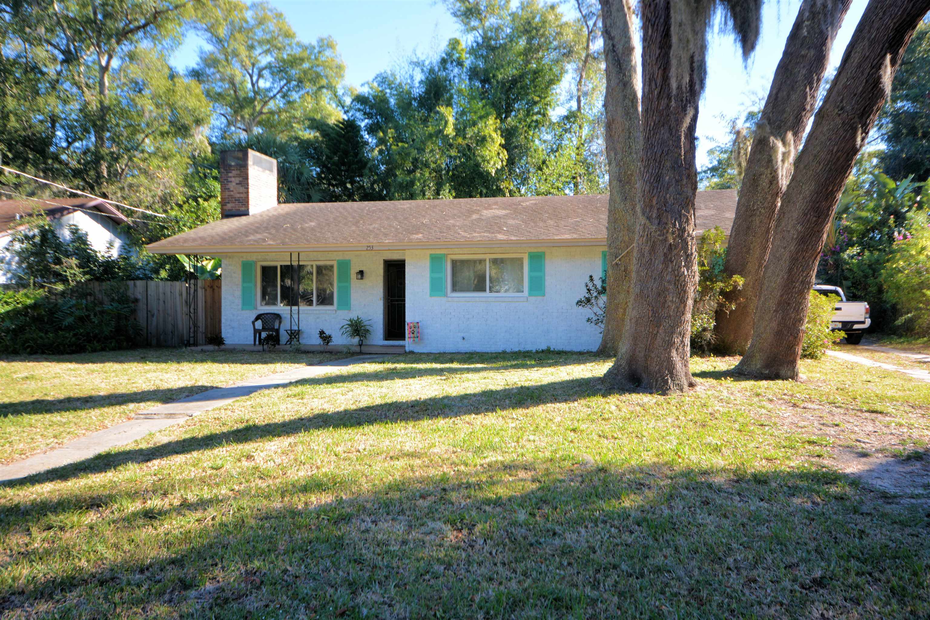 253 Mimosa Road St. Augustine, FL 32086 - Photo 4 of 42 a view of swimming pool with large trees and wooden fence
